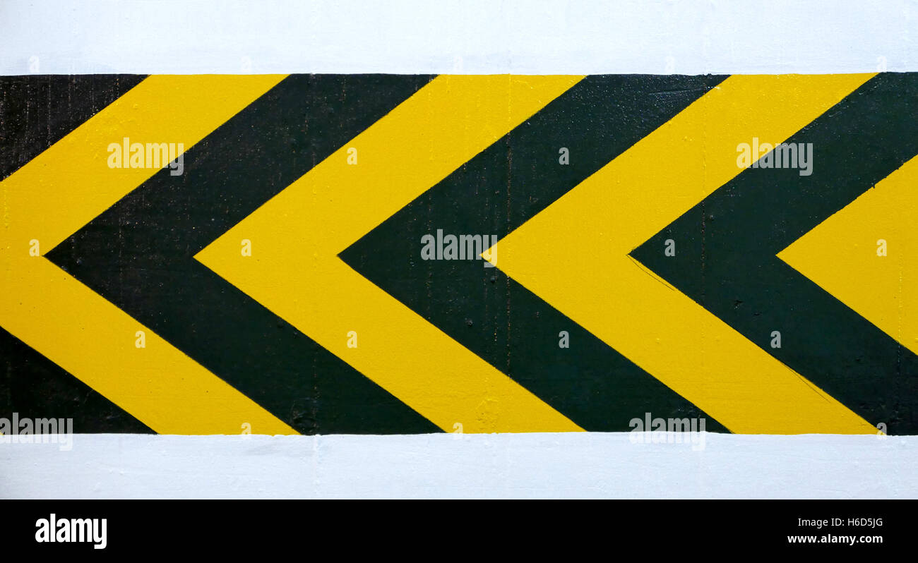 Alert left yellow and black arrow road sign for the drivers Stock Photo