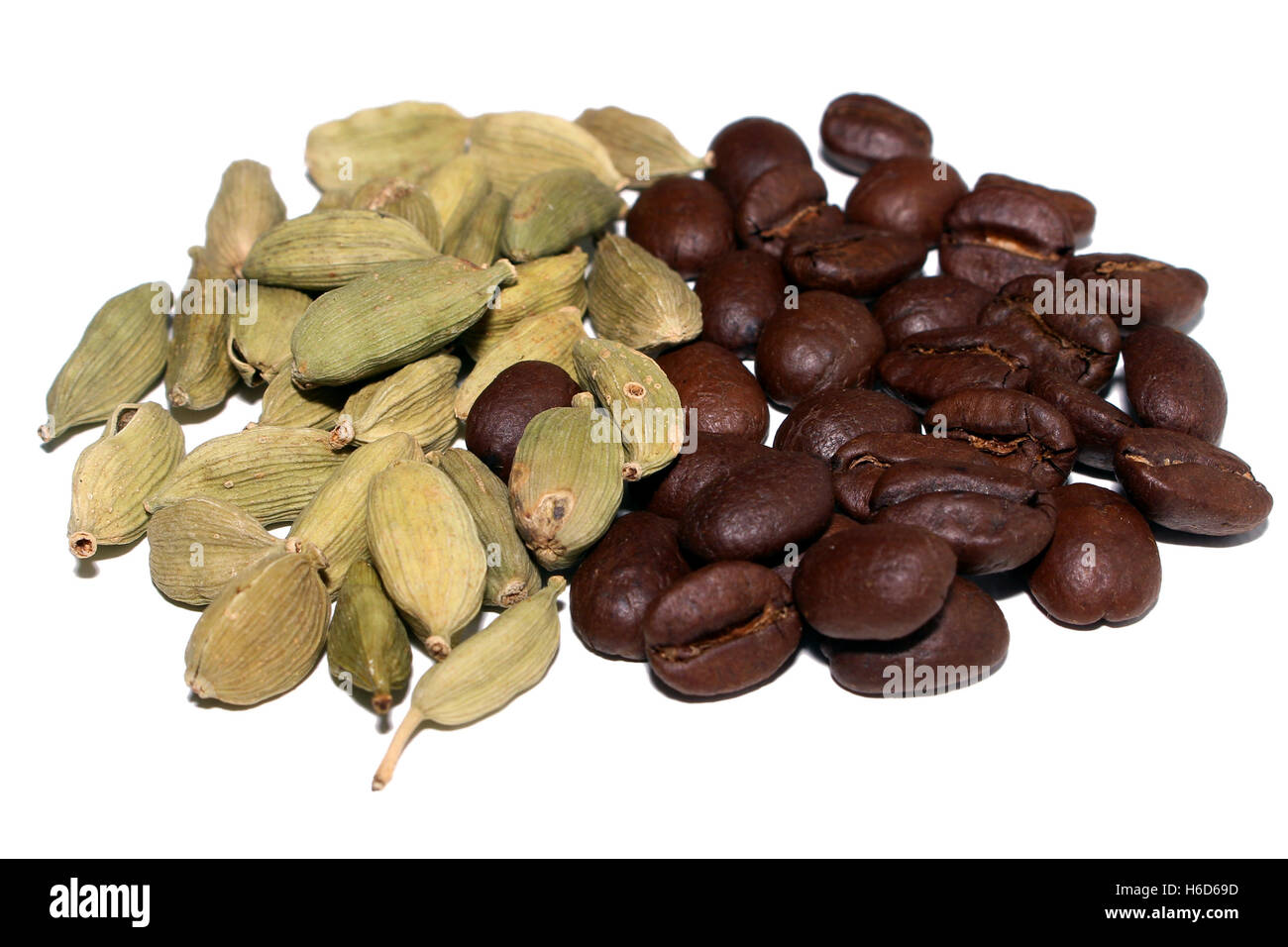 Cardamon and coffee beans piled side by side Stock Photo