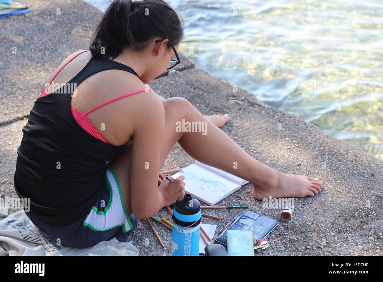 Girl paints seaside view Stock Photo