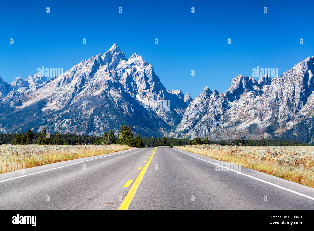 Highway going towards Teton Range in Grand Teton National Park Stock Photo
