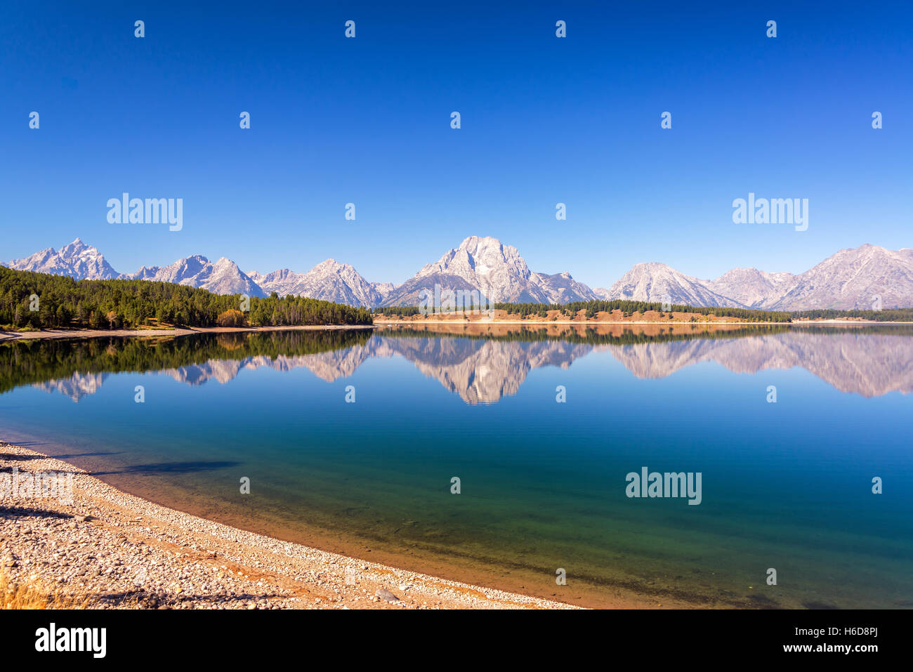 Wide angle view of the Teton Range reflected in Jackson Lake in Grand Teton National Park in Wyoming Stock Photo