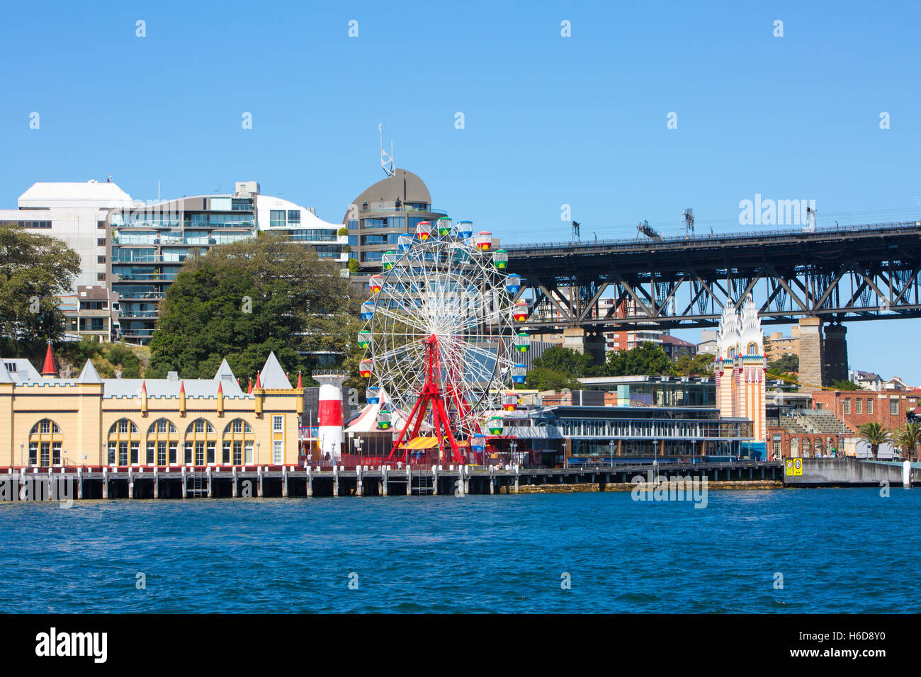 View of Luna Park amusements by Sydney harbour bridge from mcmahons point ferry wharf,Sydney,Australia Stock Photo