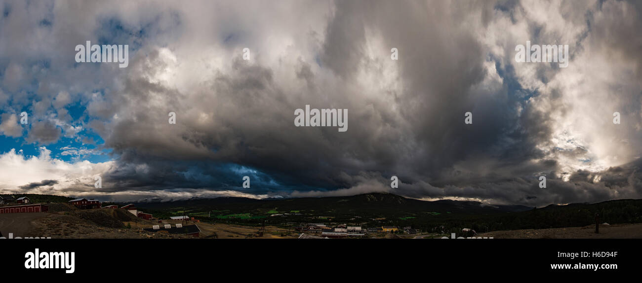 Panoramic view on Cumulus cloud which is growing over the city. Norway Stock Photo