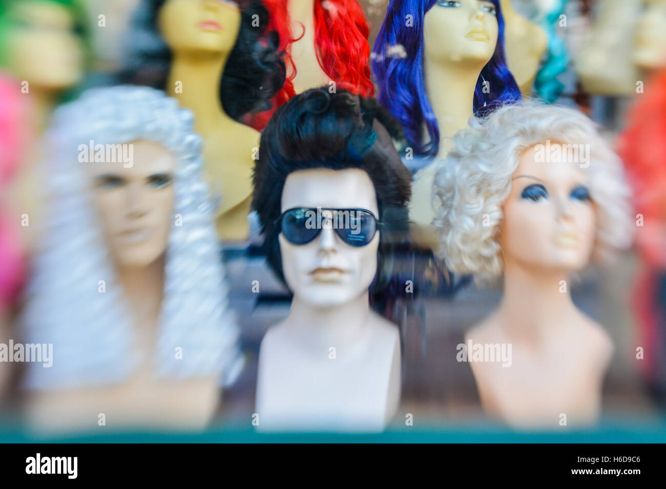 Pyramid shaped display of mannequin heads with wigs