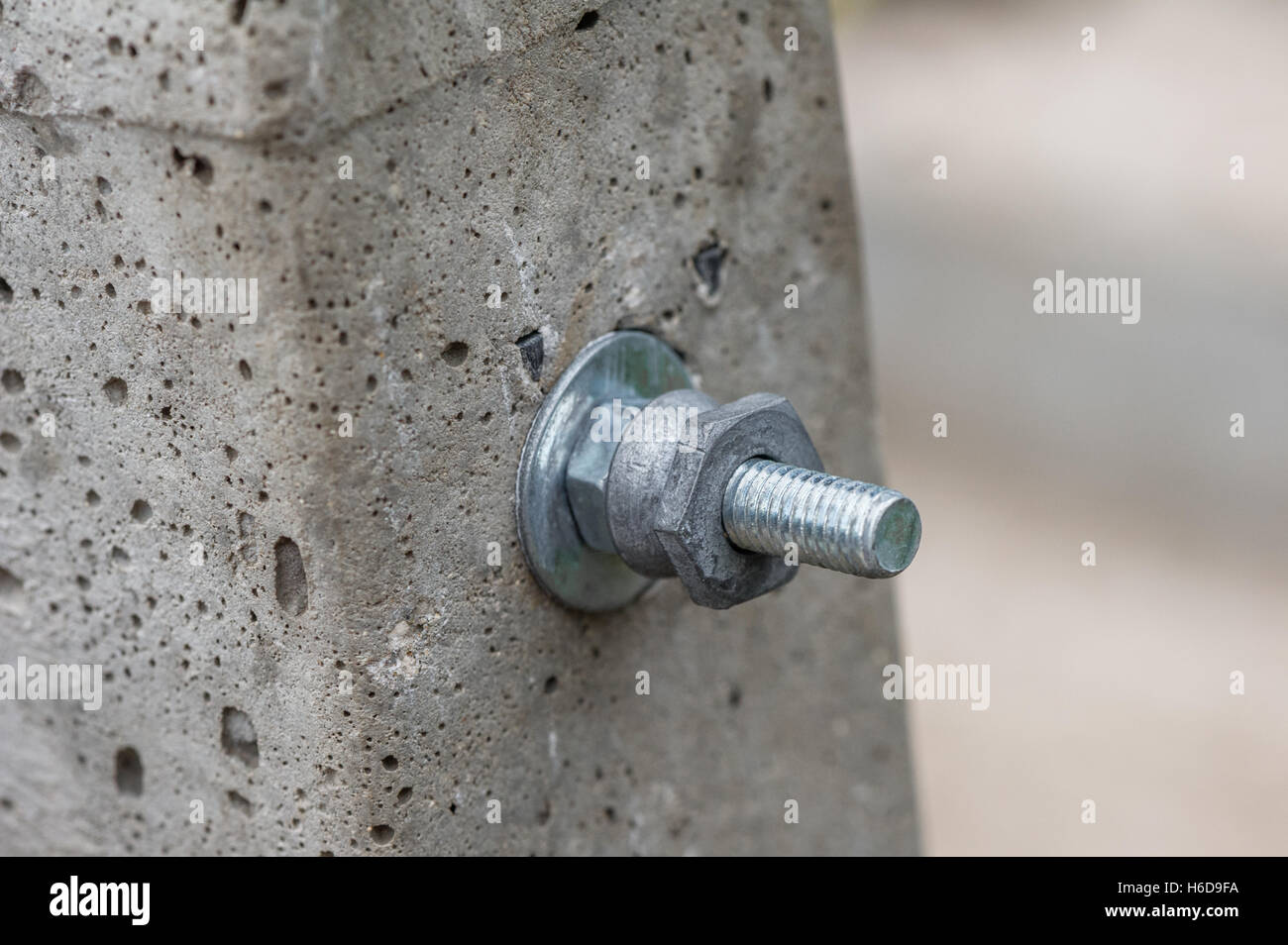 Nut and bolt fixings through a concrete post Stock Photo Alamy