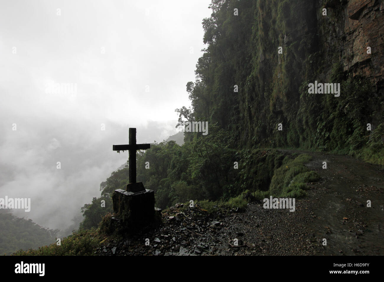 Cross along Death Road, called North Yungas Road or Camino de la Muerte, the most dangerous road, leading down to the Yungas, Coroico, Bolivia Stock Photo