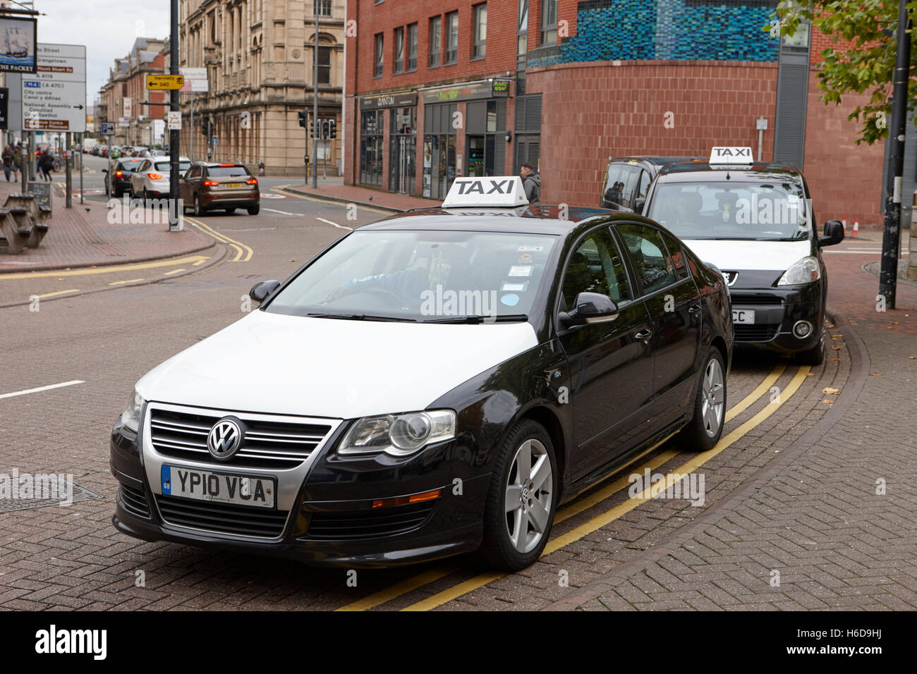 black and white taxis on a cab rank in Cardiff Wales United Kingdom Stock Photo