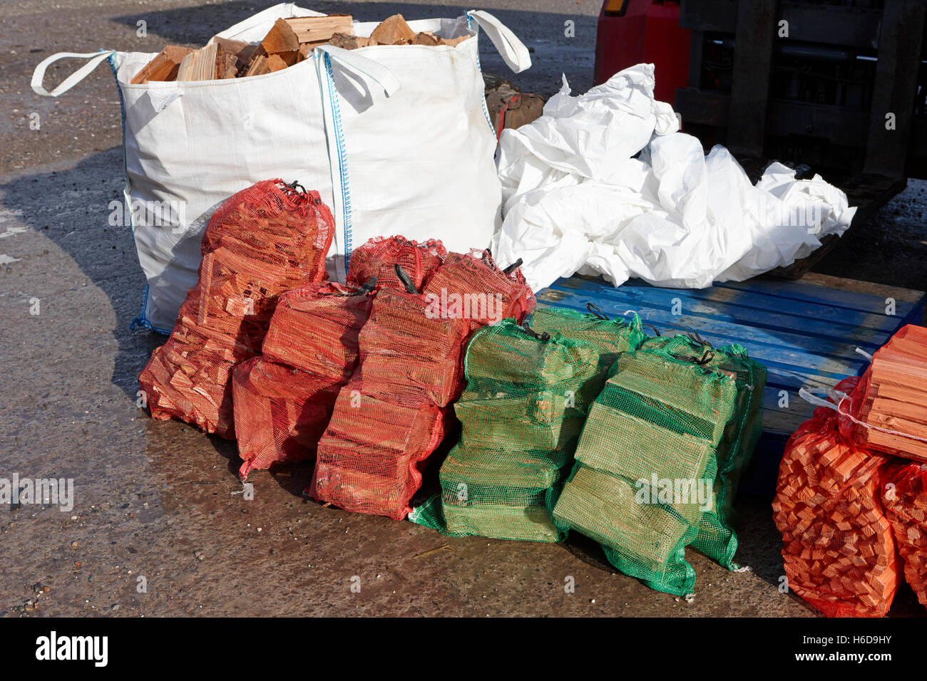 bags of firewood and sticks for sale at a farmers market in rural england Stock Photo