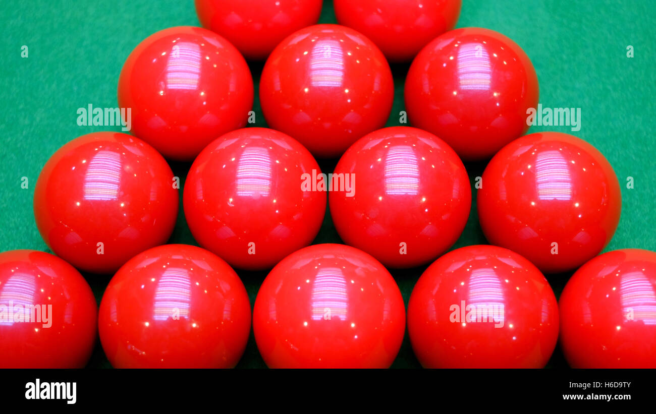 Some red snooker balls on green table Stock Photo