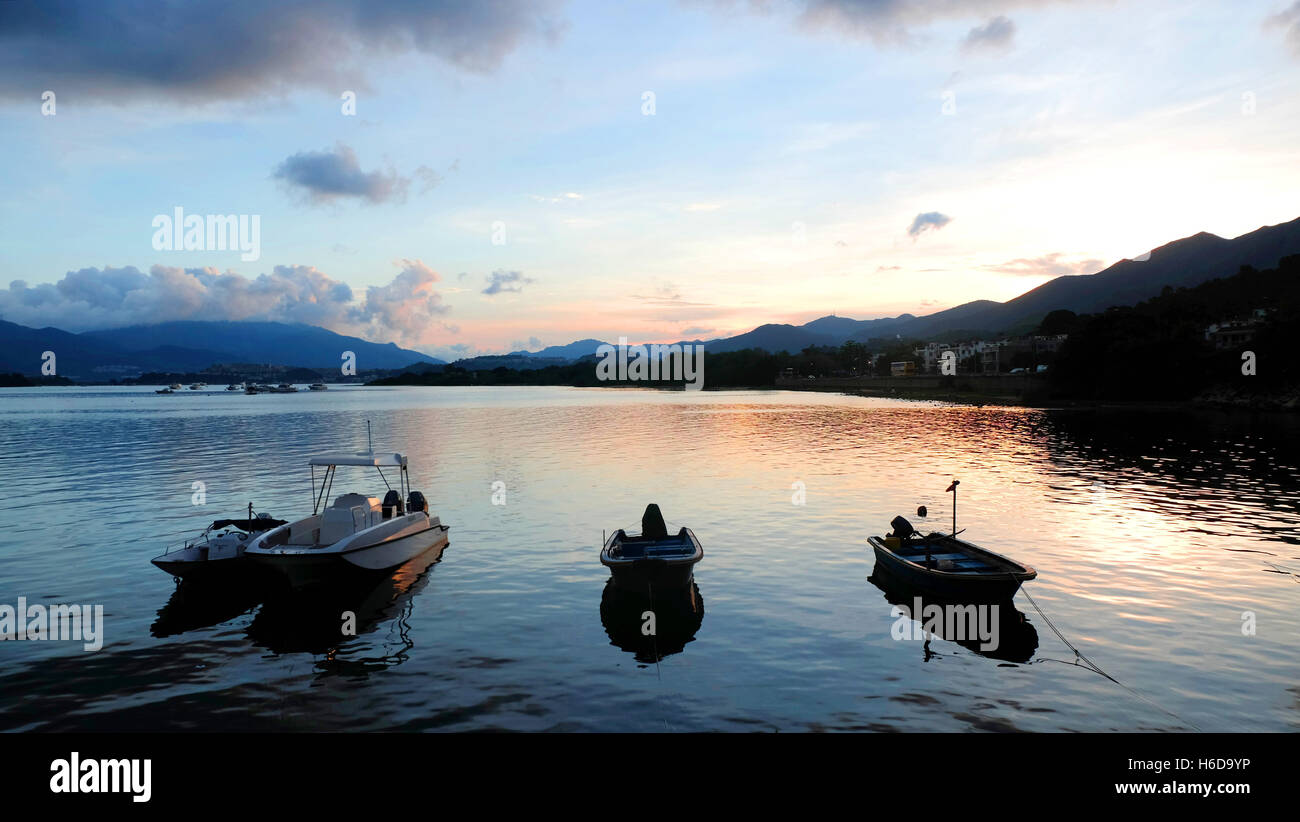 The silhouette of fishing recreational boat at sunset Stock Photo - Alamy
