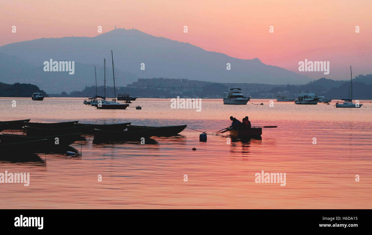 The silhouette of recreational boats, mountain and beautiful gradient sky Stock Photo