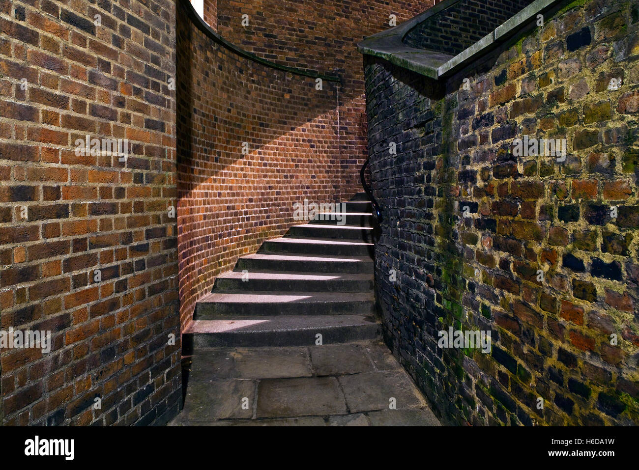 A night-time view of an eerie urban staircase in an alleyway. Stock Photo