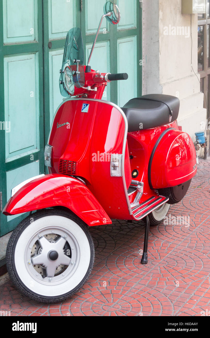 Red Vespa scooter parked on a street in Bangkok, Thailand Stock Photo ...