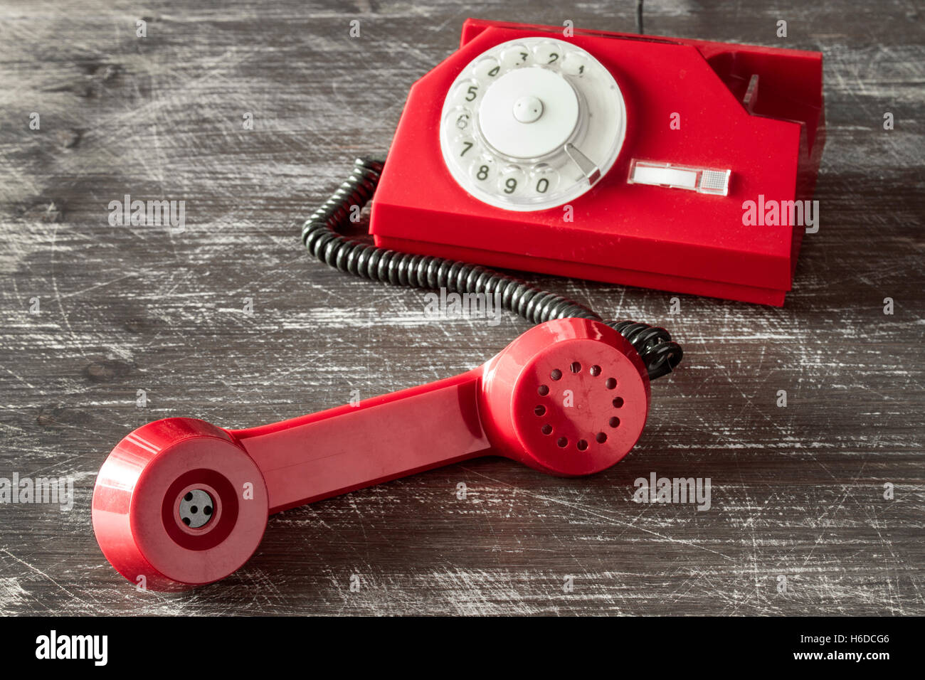 Red vintage phone with rotary dial on the wooden background Stock Photo ...