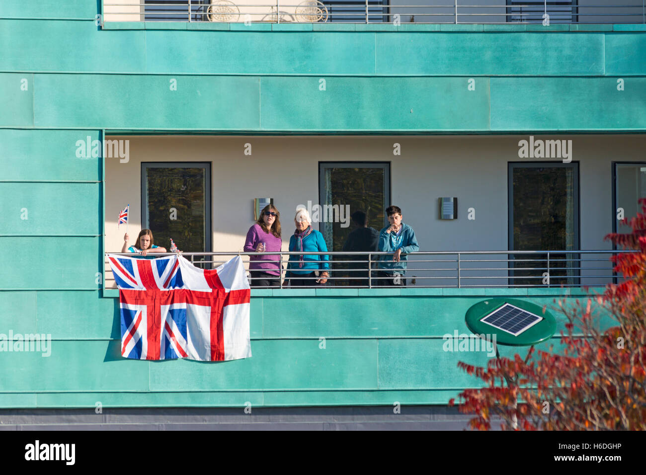 Dorchester, Dorset, UK. 27 October 2016. Royal supporters wait on balcony overlooking Dorchester South train station for the arrival of the Royal Party on the Royal train (Her Majesty the Queen accompanied by Prince Philip, Charles Prince of Wales and Camilla Duchess of Cornwall) before they go on to Poundbury Credit:  Carolyn Jenkins/Alamy Live News Stock Photo