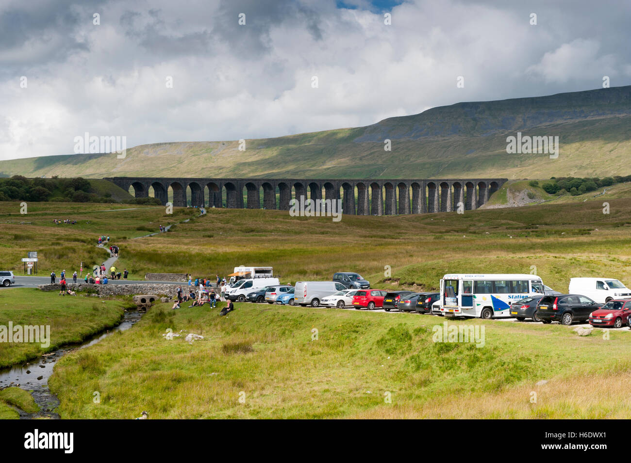 Ribblehead Viaduct on the Settle to Carlisle Railway, with lots of tourists around. Yorkshire Dales National Park, UK. Stock Photo