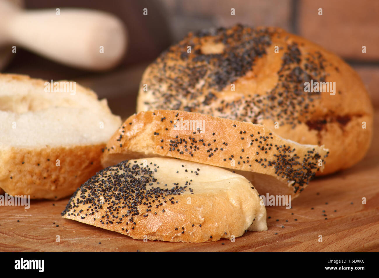 Sliced kaiser bread roll with poppy seed Stock Photo Alamy