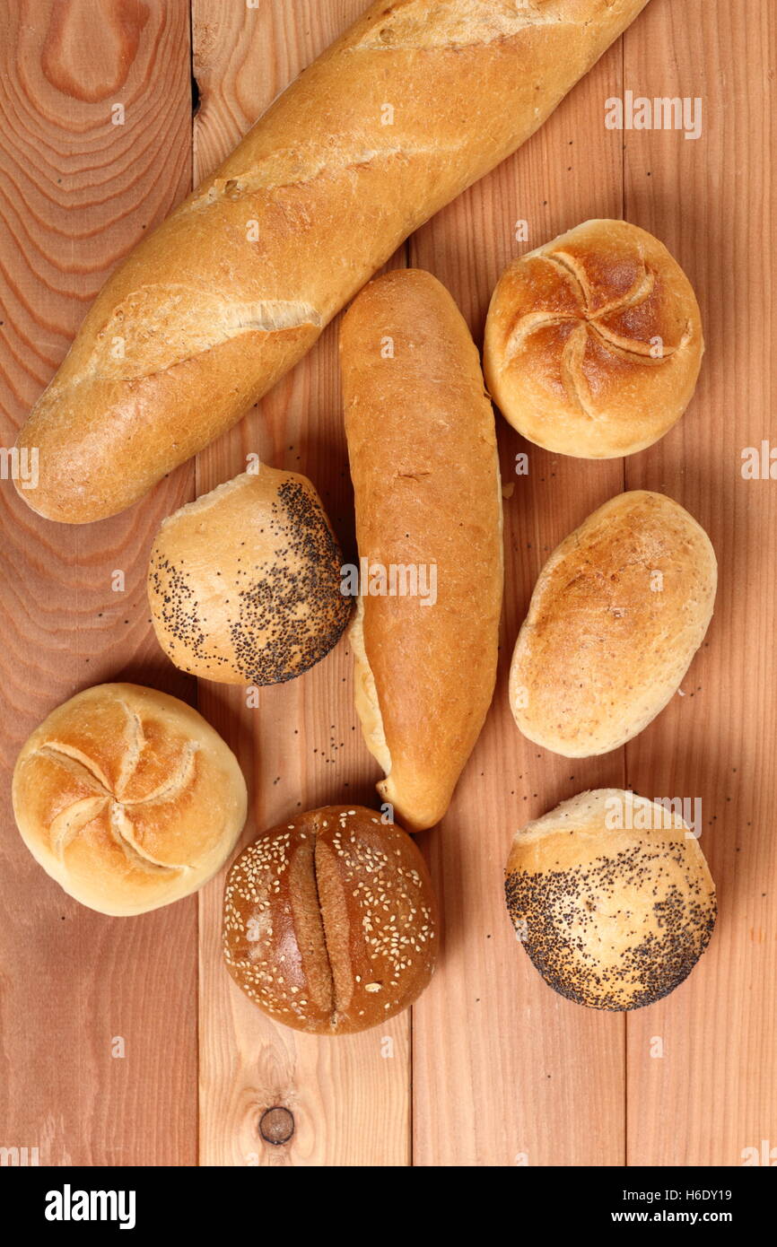 Assorted bread rolls at wooden plank background. Directly Above Stock