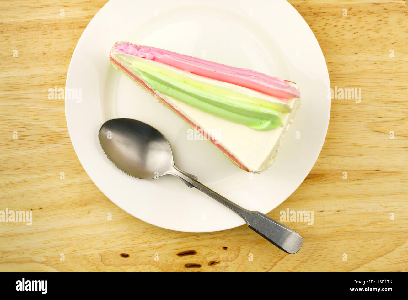 Layer cake on a white plate with a metal spoon Stock Photo