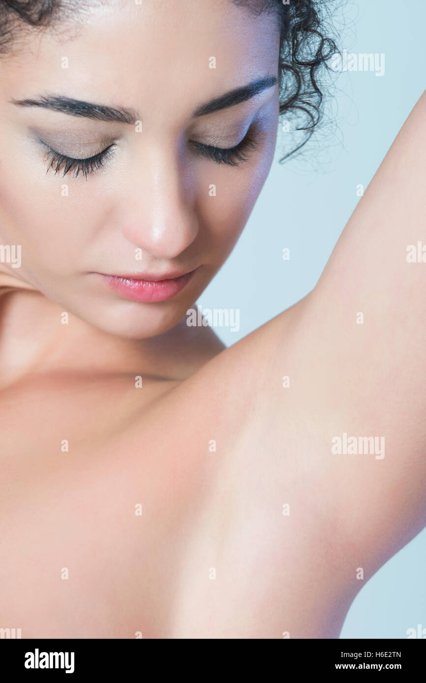 Close up of a young woman looking at shaved armpits Stock Photo