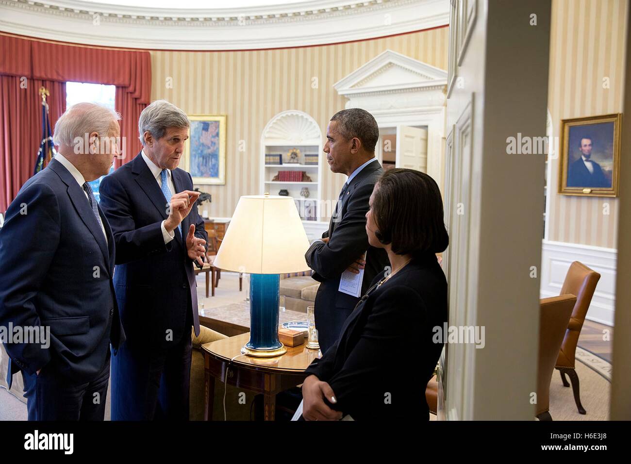 U.S. President Barack Obama, Vice President Joe Biden, and National Security Advisor Susan Rice listen to Secretary of State John Kerry in the White House Oval Office March 9, 2015 in Washington, DC. Stock Photo
