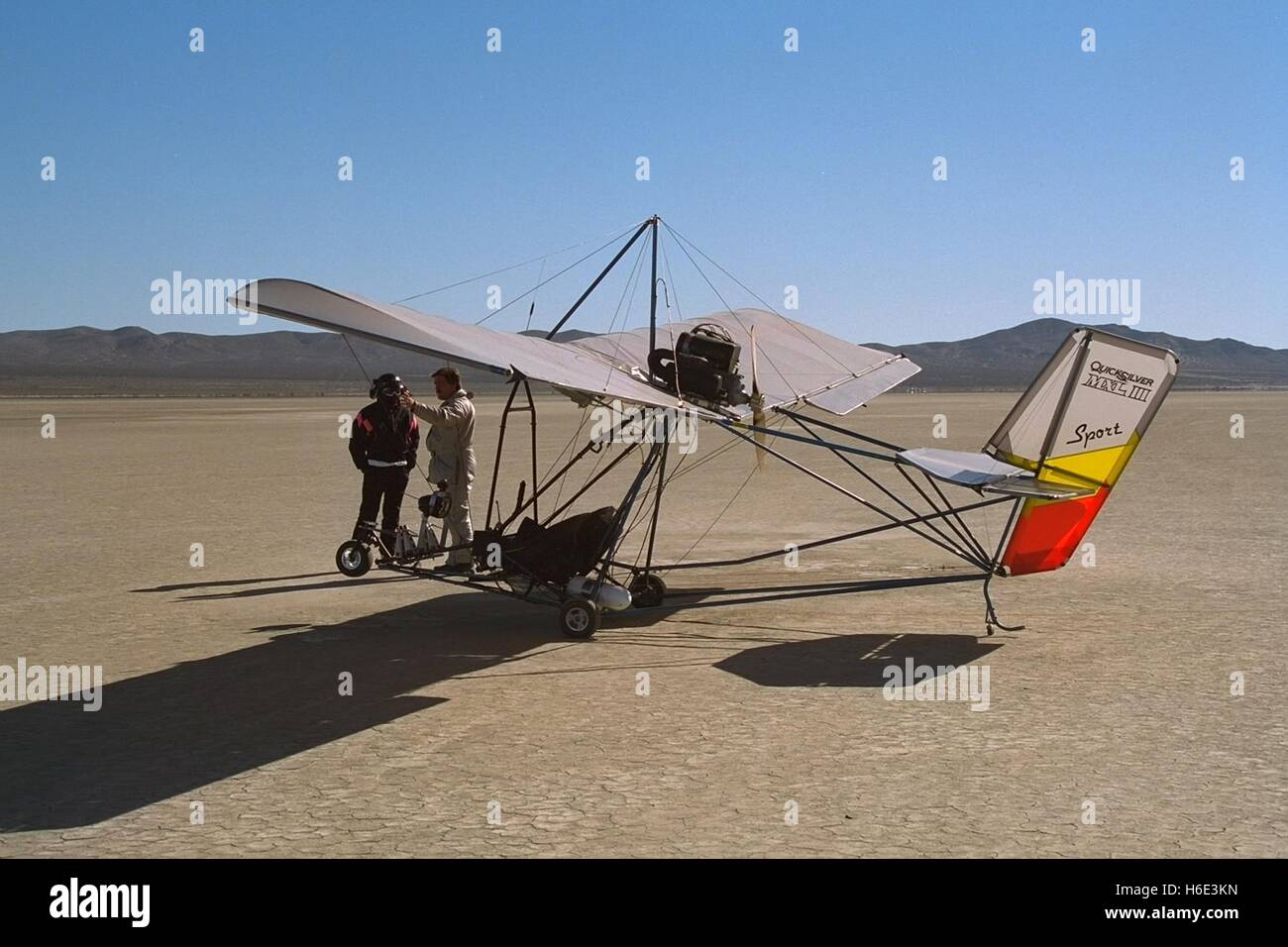 Pilots stand near a Quicksilver MXL ultralight aircraft at the El Mirage Dry Lake Off-Highway Vehicle Recreation Area in the Mojave Desert near Los Angeles, California. Stock Photo