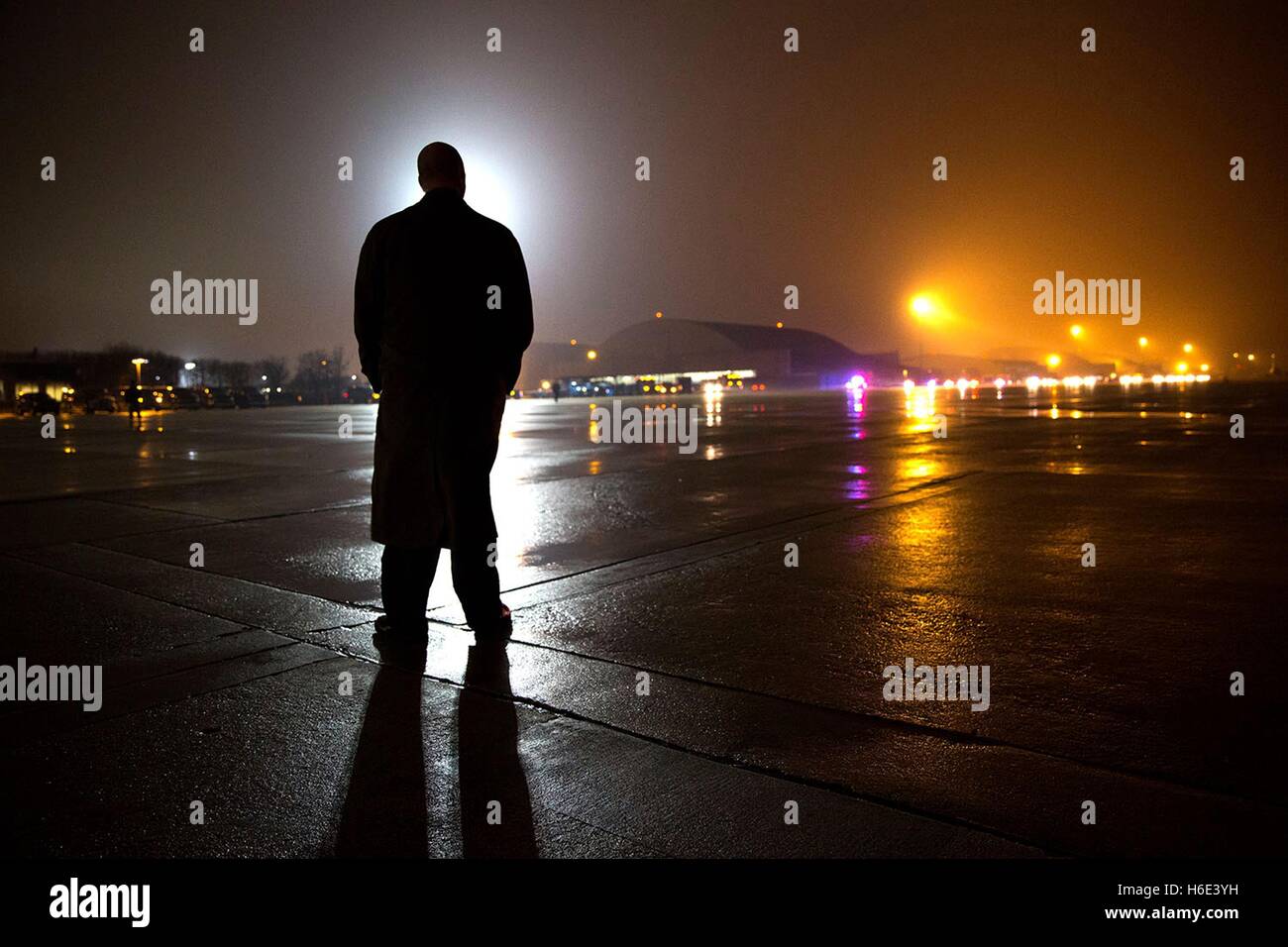 A Secret Service agent stands on the tarmac waiting for U.S. President Barack Obama to arrive by motorcade at Joint Base Andrews January 24, 2015 in Prince Georges County, Maryland. Stock Photo
