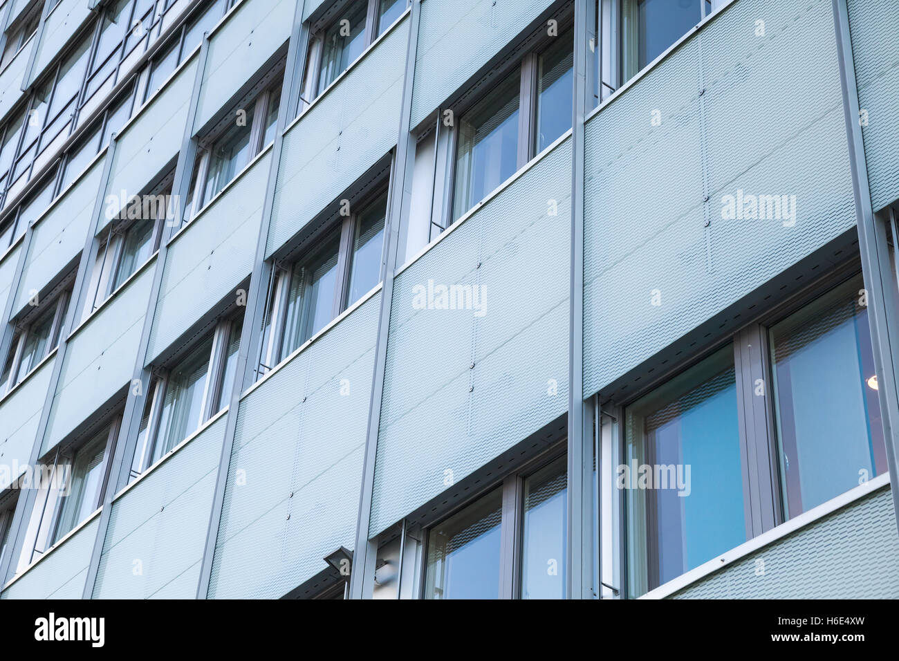 Abstract facade of modern office building with windows and decorative metal grid Stock Photo