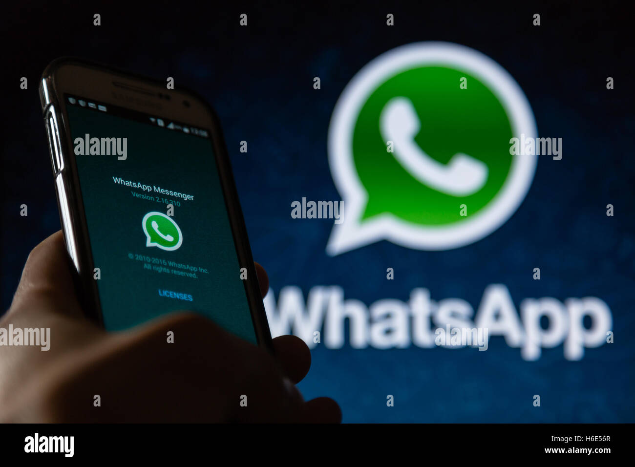 A smartphone display shows WhatsApp Messenger application Stock Photo