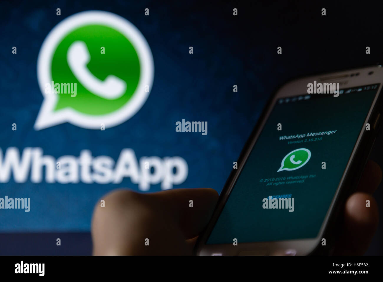A smartphone display shows WhatsApp Messenger application Stock Photo