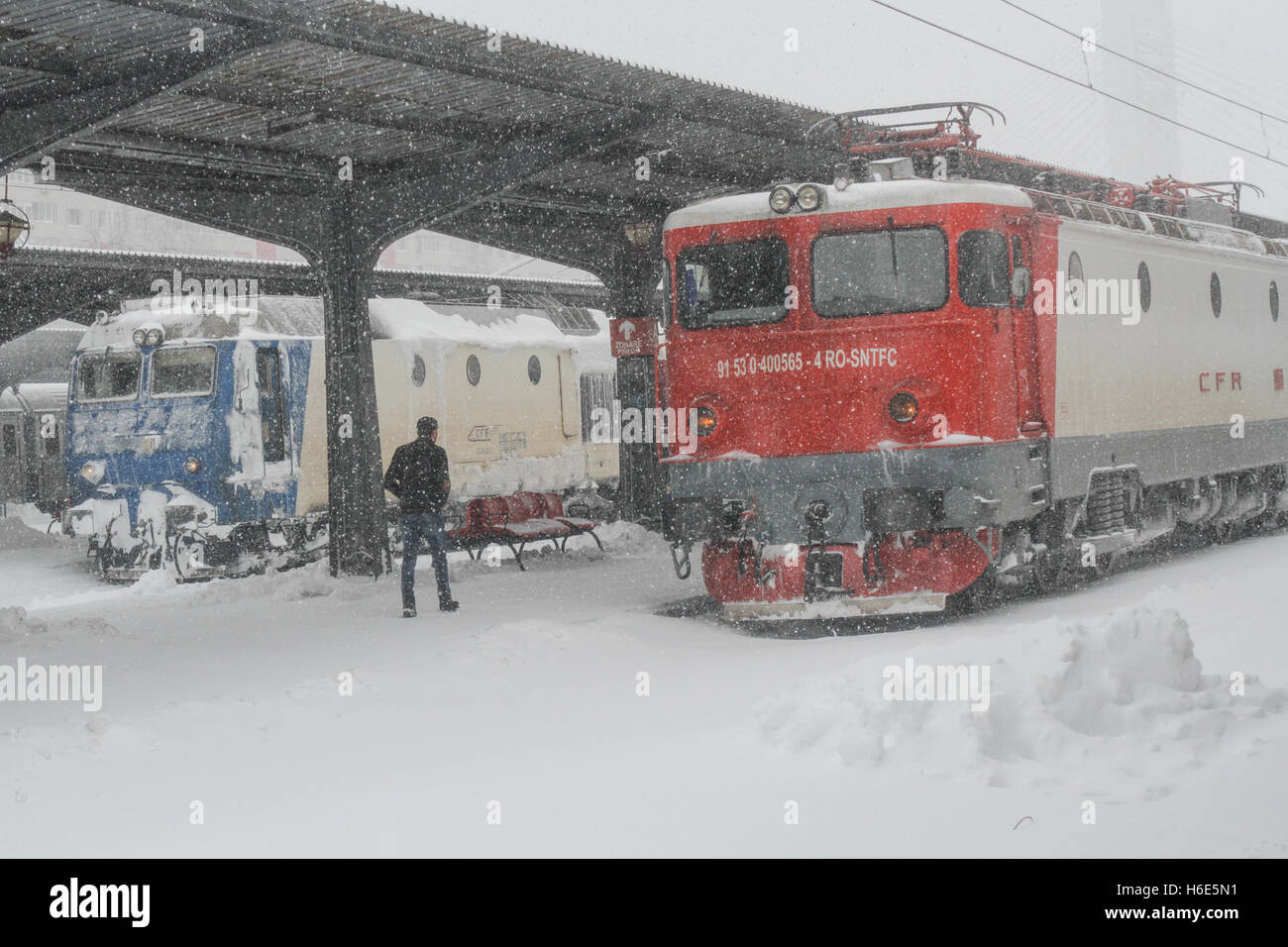 Bucharest, Romania, 17 January 2016: A man is walking in Gara de Nord main railway station, after a heavy snowfall. Stock Photo