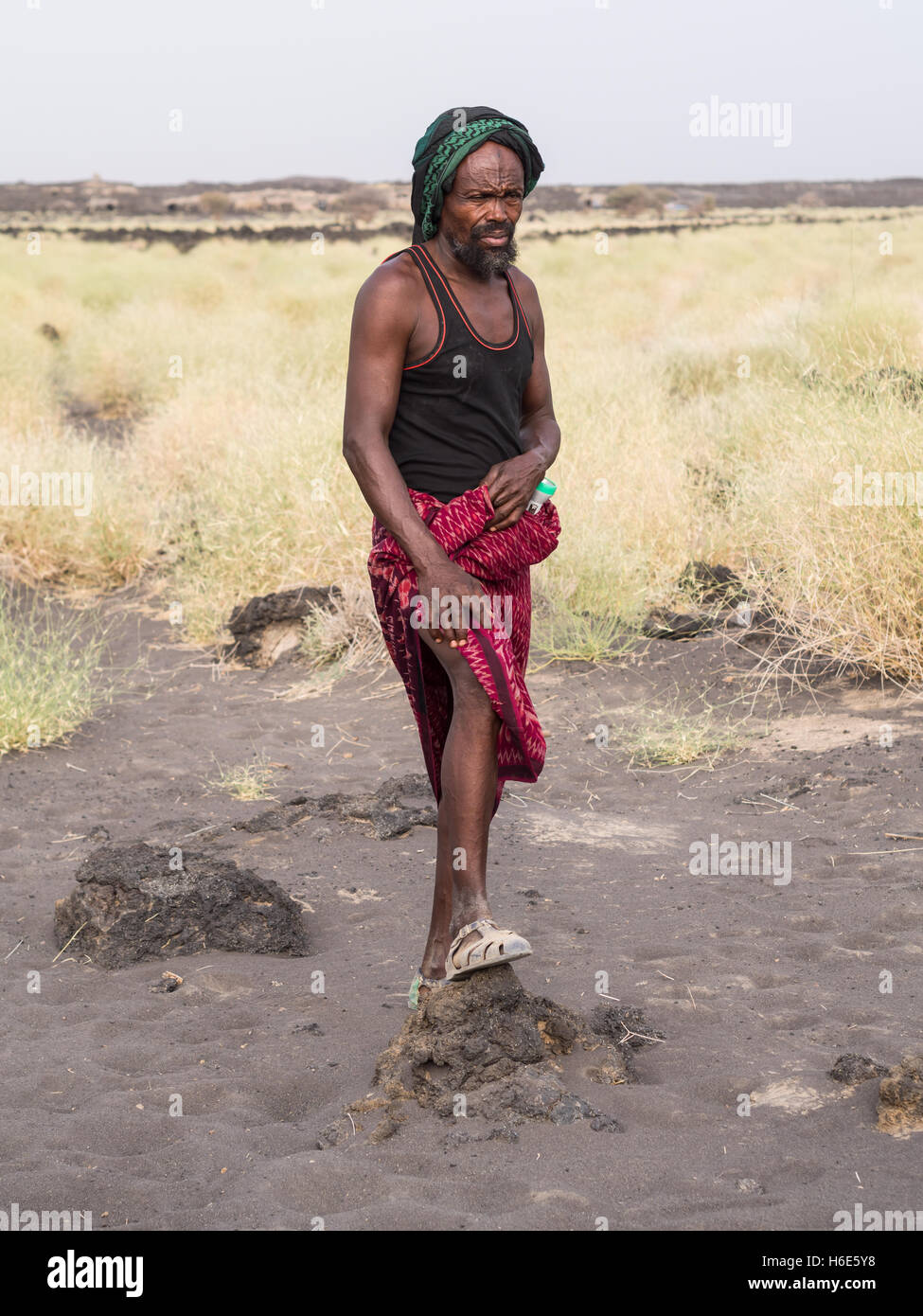 Local tourist guide leading a group down from Erta Ale active volcano in Afar Region in Ethiopia, Africa. Stock Photo