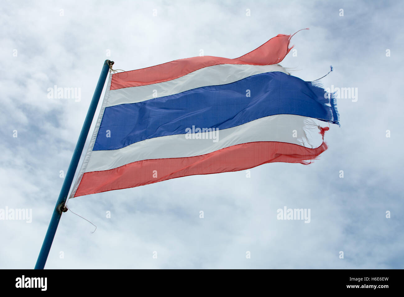 Wavy old Kingdom of Thailand flag against blue sky Stock Photo