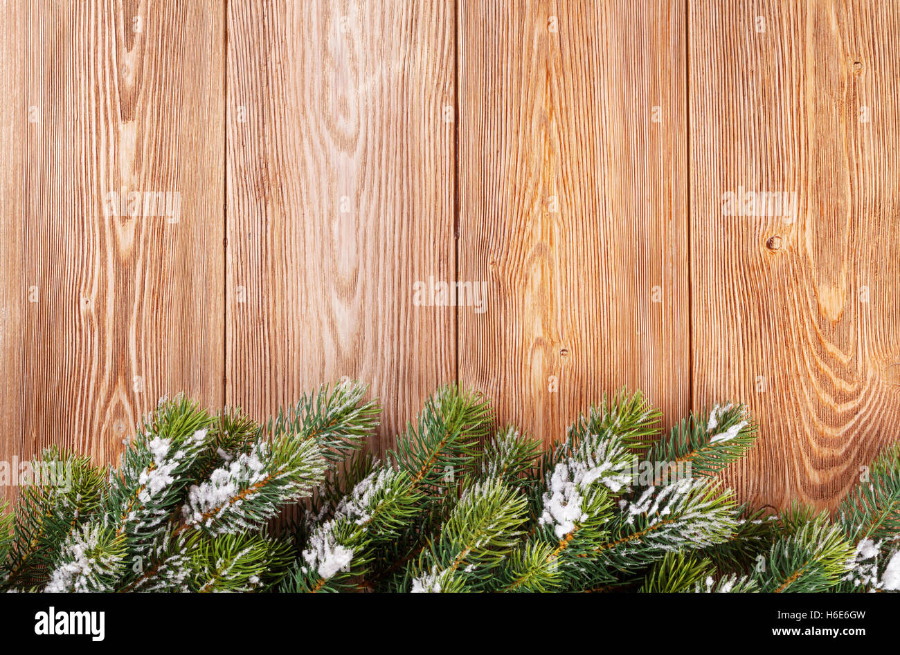 Christmas wooden background with snow fir tree. View with copy space ...