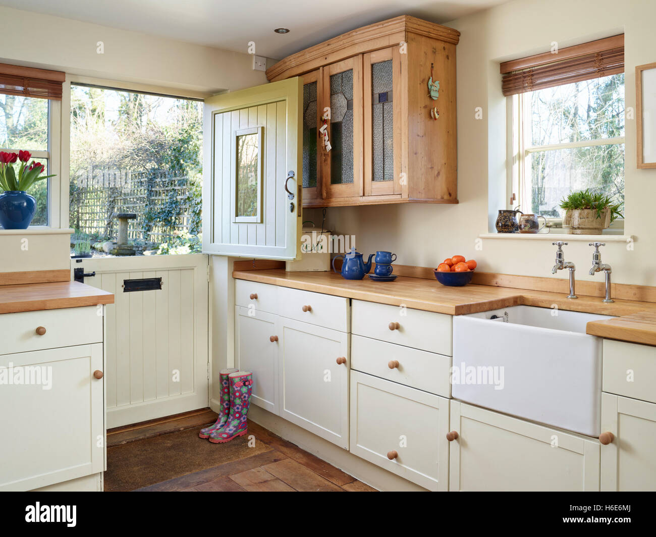 A contemporary contry kitchen Bincorporating a Belfast sink & wood work surfaces. Oxfordshire, UK Stock Photo