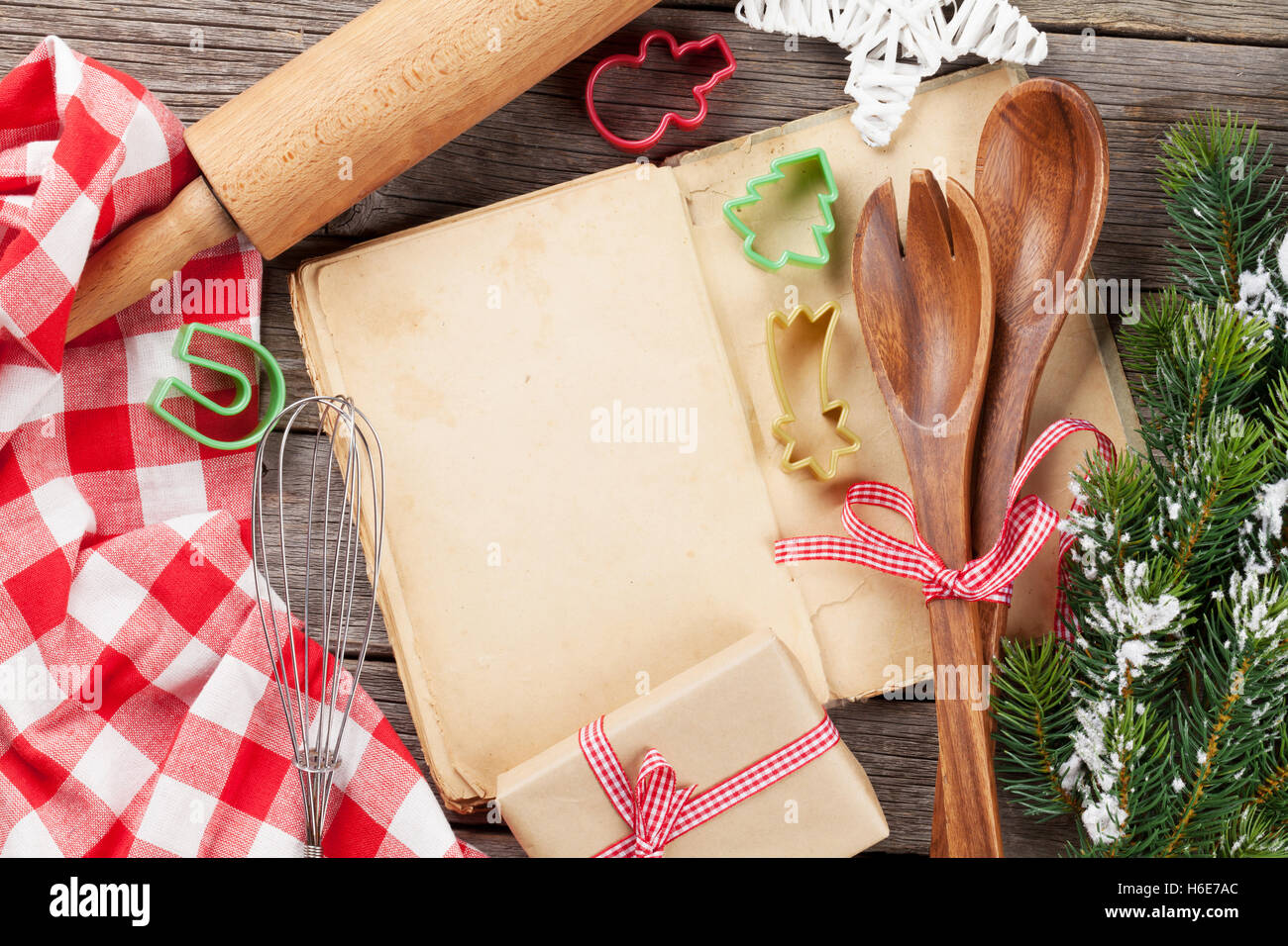 Cook book and utensils on wooden table. Christmas cooking. Top view with copy space Stock Photo