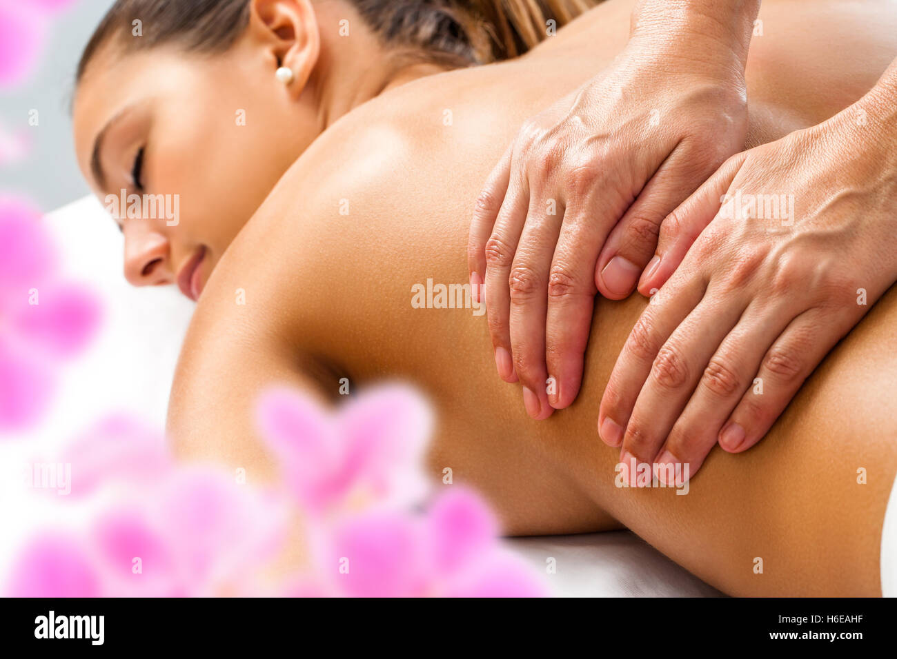 Close up of Hands doing Relaxing back massage on woman in spa. Stock Photo