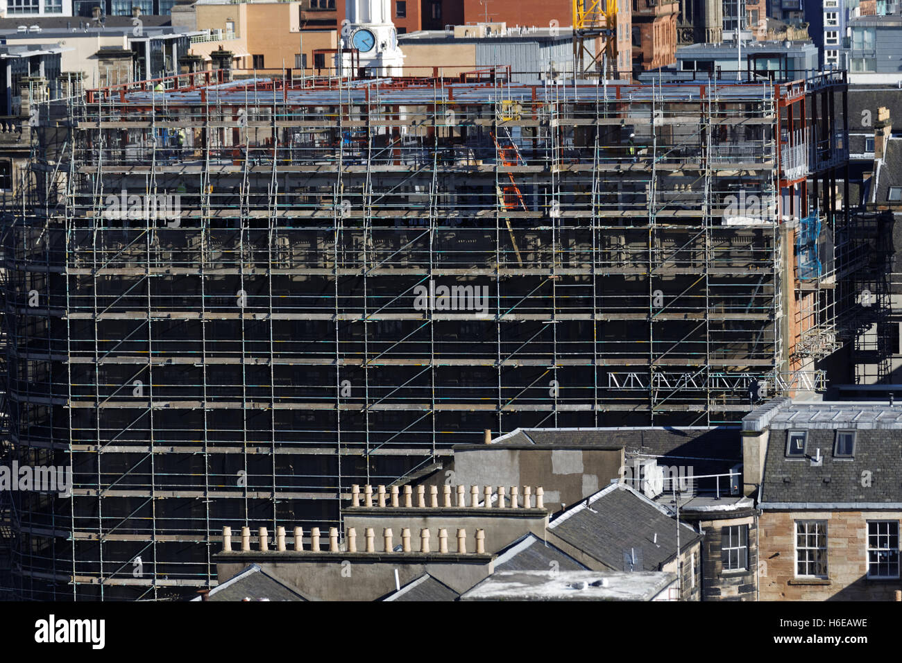 graphic scaffolding over the roofs and chimneys pots of glasgow Stock Photo