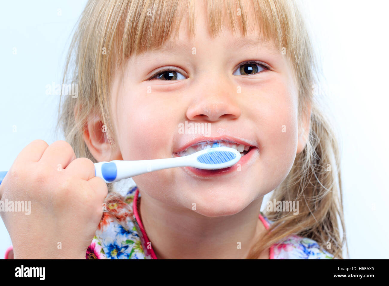 Macro close up Face shot of infant brushing teeth. Stock Photo