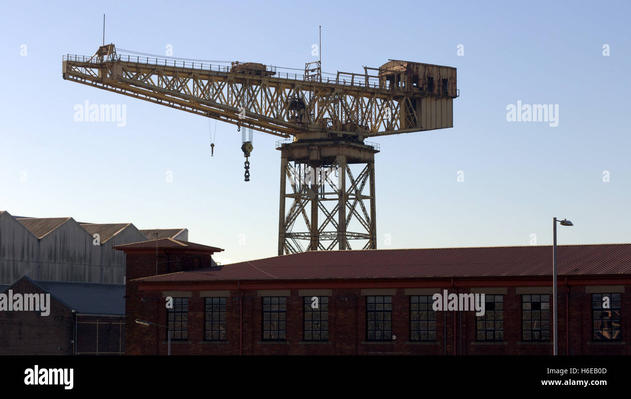 Clyde Titan Crane, Whiteinch Crane next to a junkyard, and itself next to a listed building of the former Diesel works Glasgow Stock Photo