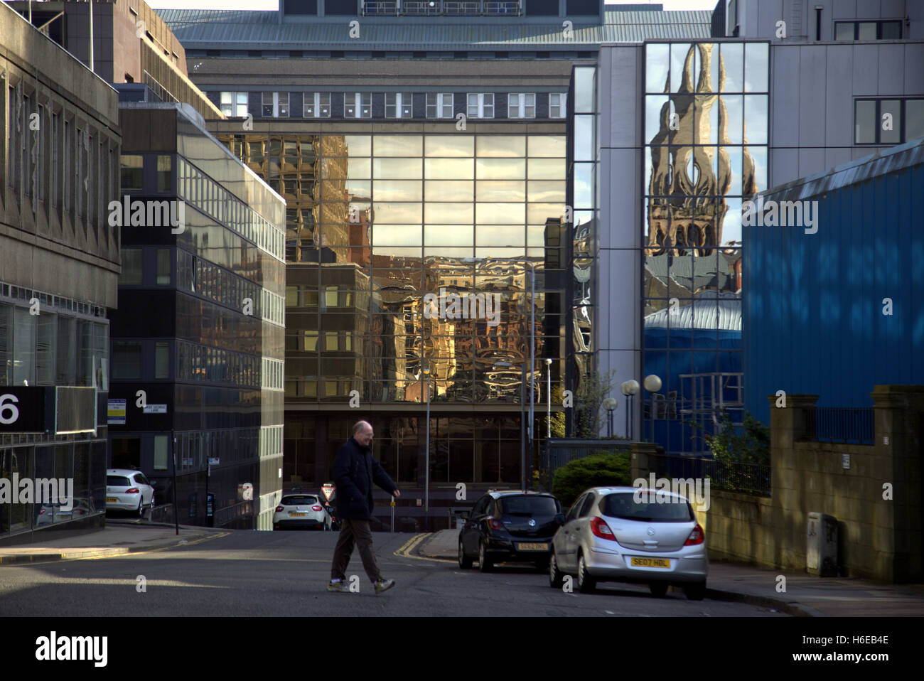 Refkections in office blocks in Glasgow commercial distict church and victorian buildings in holland street Stock Photo