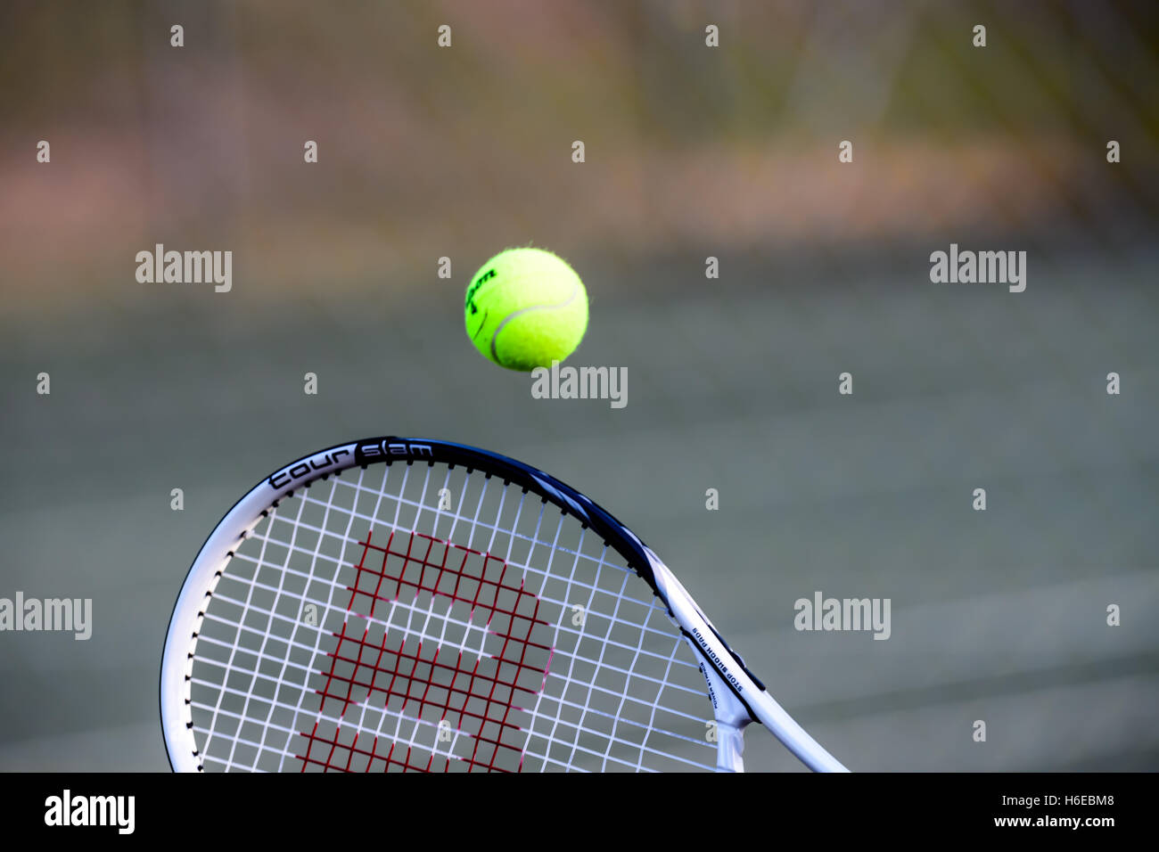 Tennis ball hitting a racket Stock Photo
