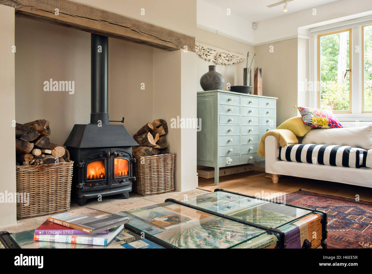 A stylish, colourful living room with a wood burning stove & up cycled furniture Stock Photo