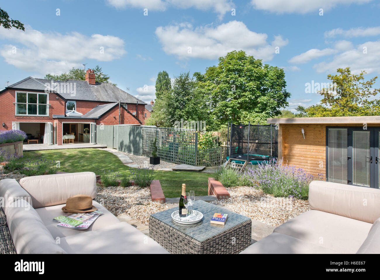 A British garden on a sunny summers day looking towards the home. Patio