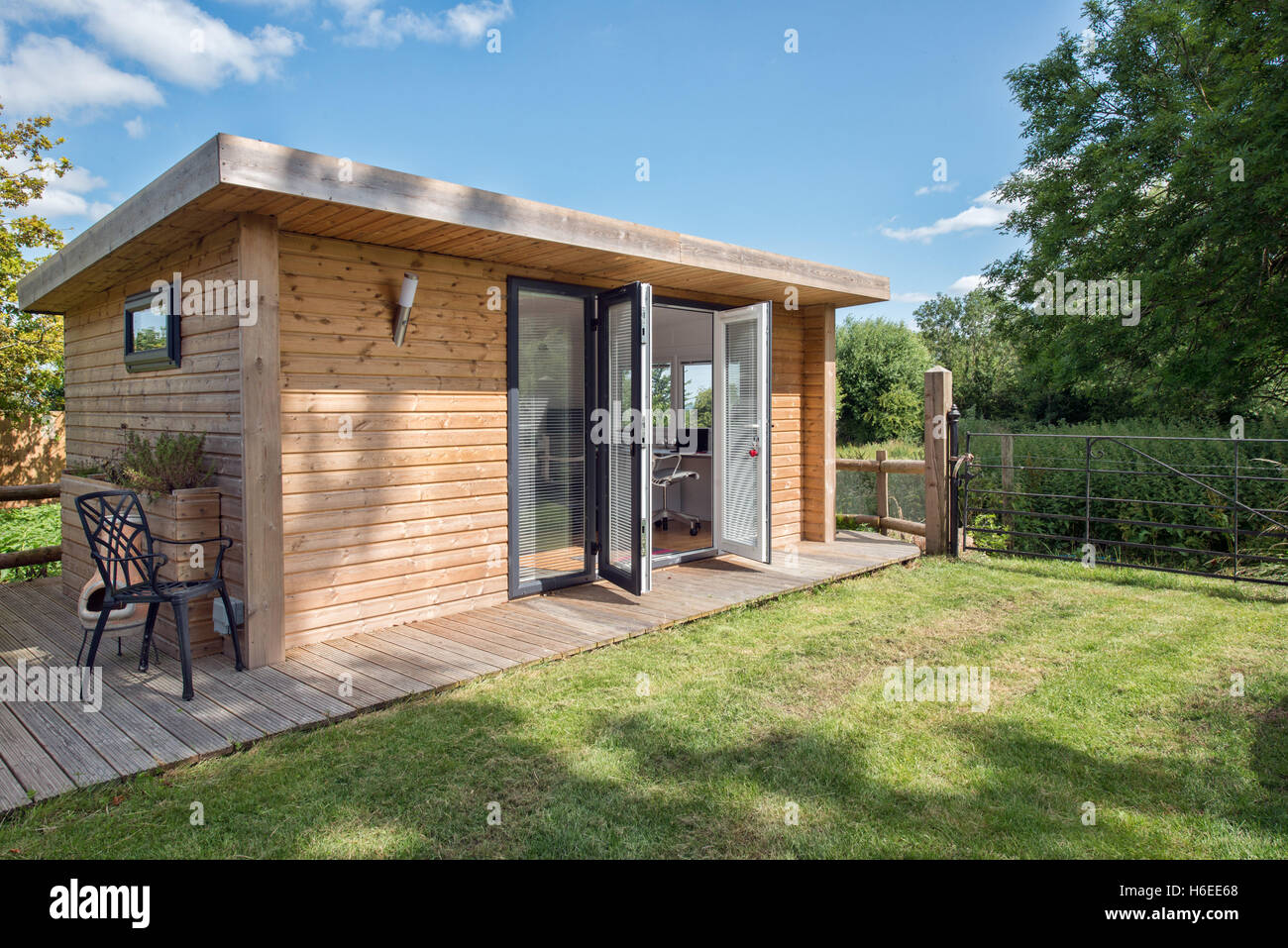 A home office built into a modern shed in the garden of a home in the UK. Stock Photo