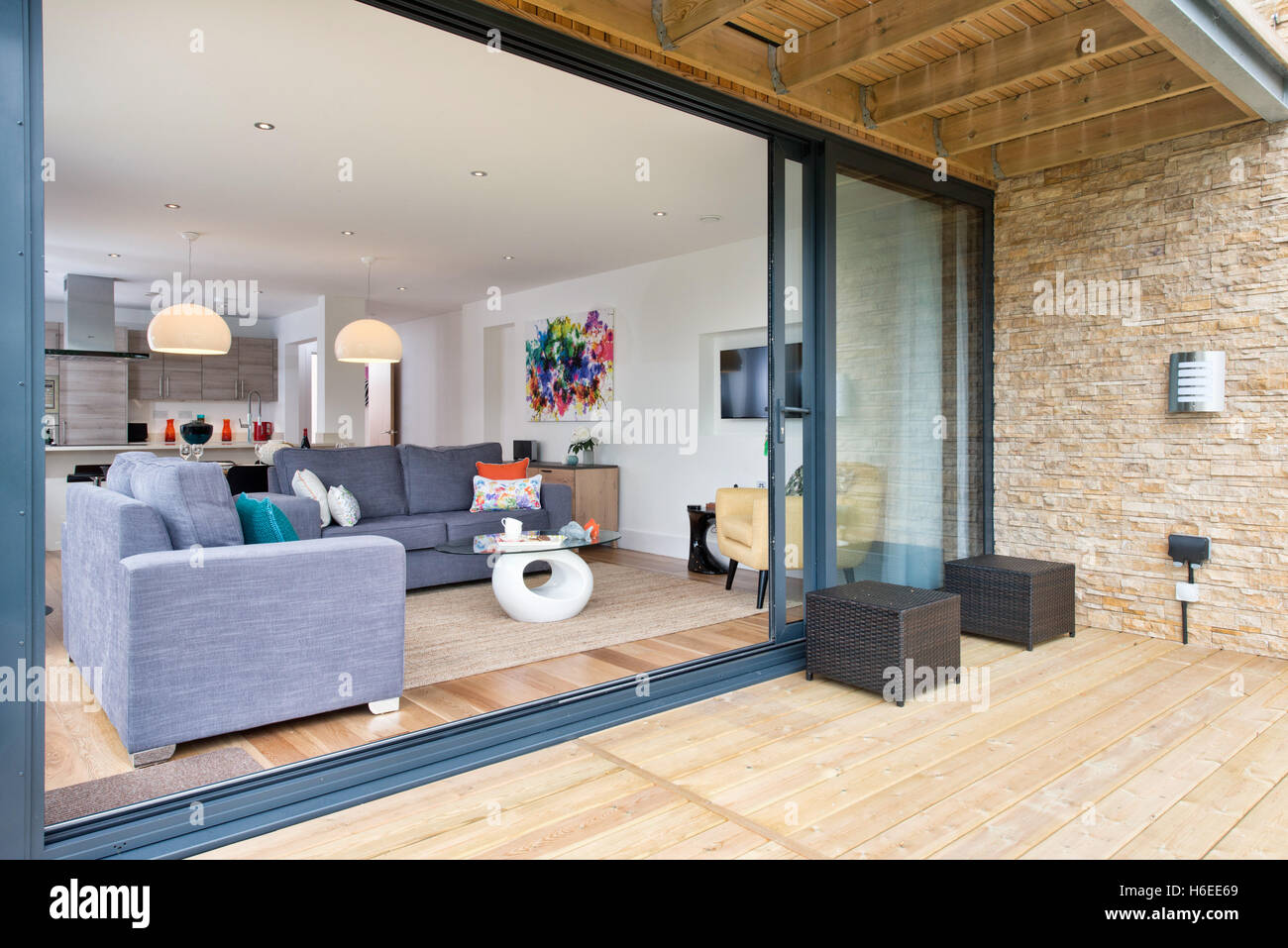 An Open Plan Living Room Diner Kitchen With Large Glass Sliding