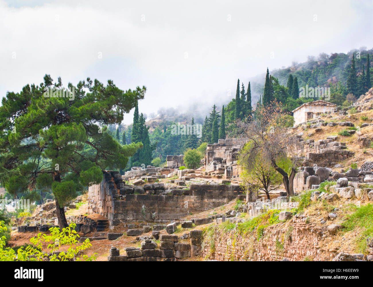 The ruins of antique Delphi with the Athenian Treasury on the