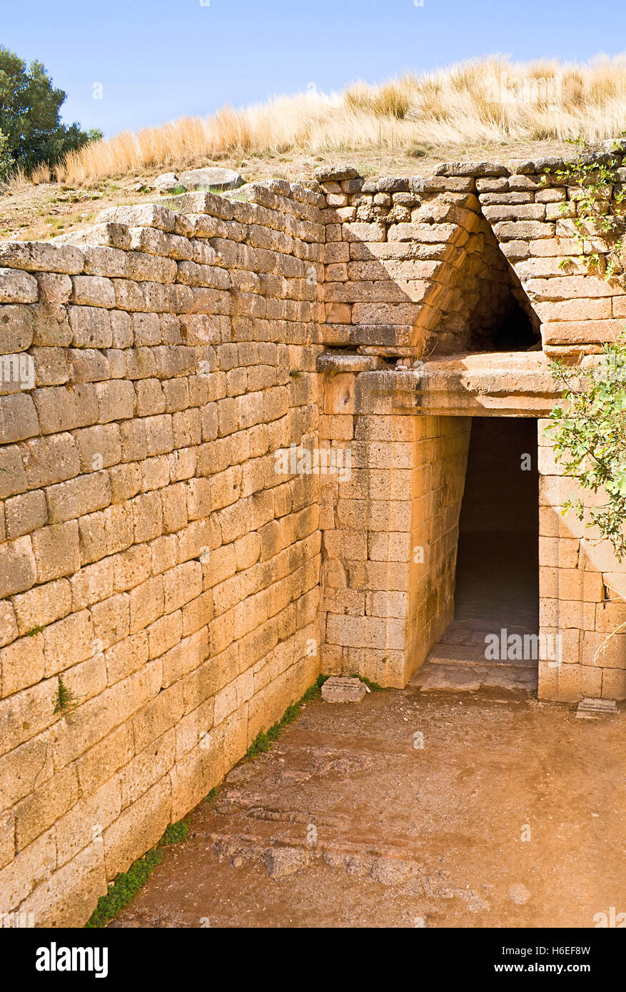 A beehive tomb, also known as a tholos tomb located in the ancient Mycenae, Greece. Stock Photo