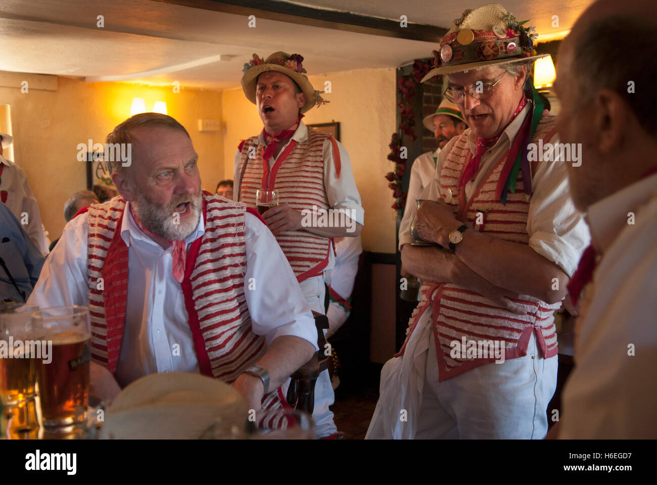 Village Pub Uk interior people. Morris men relaxing during a break from their dancing. Singing traditional folk songs,  Thaxted Essex 2000s HOMER SYKES Stock Photo