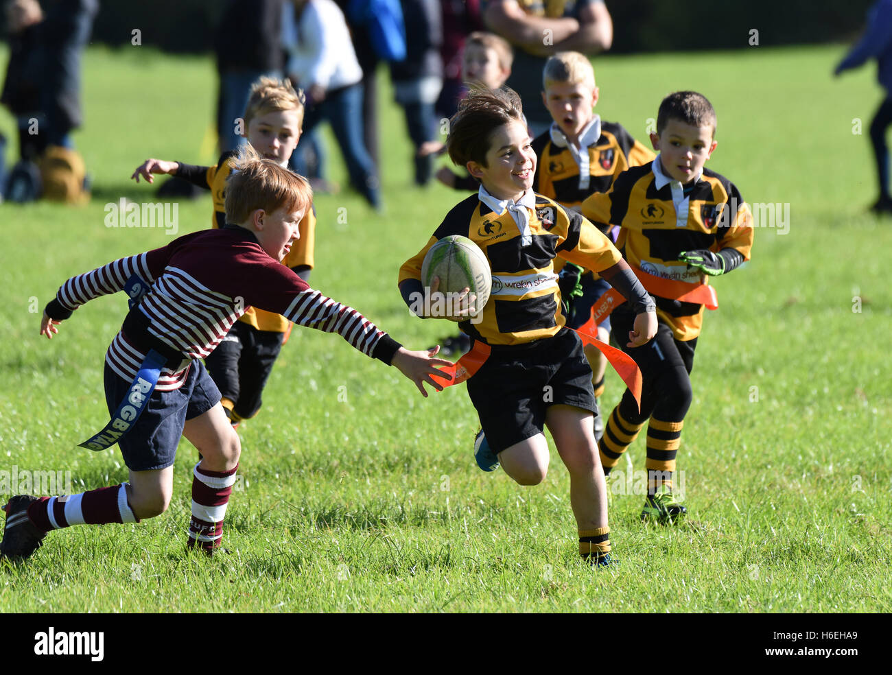 Happy smiling boy playing Junior childrens tag rugby match action Britain Uk children childrens sport  healthy activity sport boys sports Stock Photo